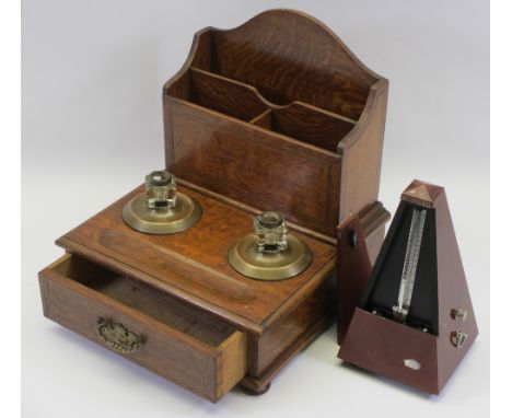 CIRCA 1900 OAK TABLETOP STATIONERY/PEN STAND and a modern mahogany effect metronome, 31cms H, 28cms W, 27cms D the stand