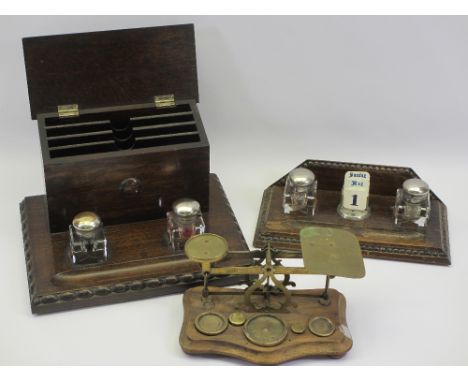 VINTAGE OAK DESK STANDS (2) and a set of postal scales, both stands have twin lidded ink bottles, one with lidded stationery 