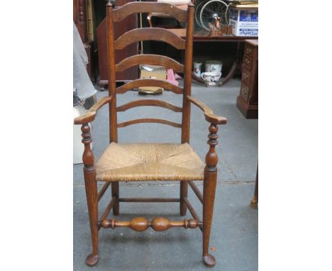 19th century rush seated country style ladder back armchair, on stretchered supports. Approx. 119cm high 