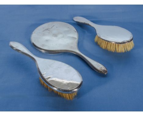 Silver backed mirror and two brushes, marks for London