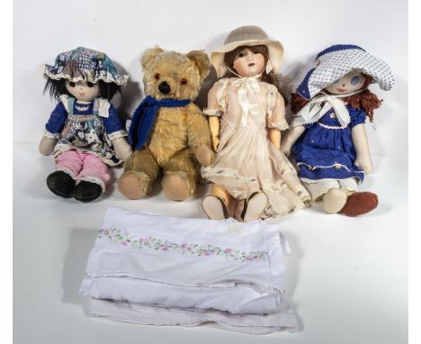 Three dolls and a Teddy bear