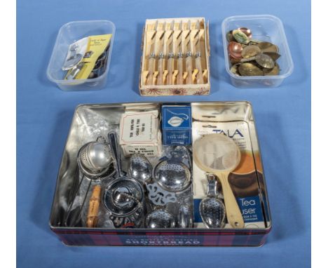 A collection of vintage tea strainers, caddy spoons and knives