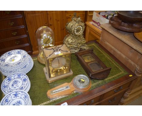 A Rococo style gilt metal mantel clock; together with three other clocks and a barometer 