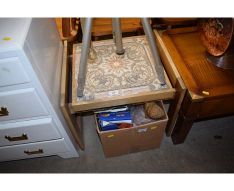 A teak and tile topped coffee table 