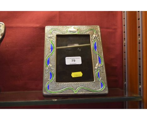 An enamel decorated white metal photo frame 