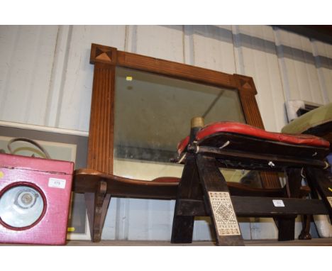 An oak framed wall mirror and shelf 