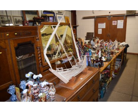 A wooden model boat on stand