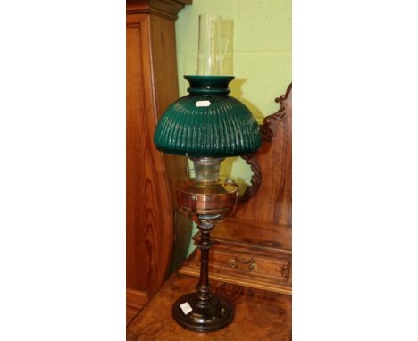 A turned wooden and copper oil lamp with green glass shade 