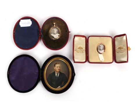 Two photographic portrait miniatures in gold coloured frames and fitted cases; and a further portrait miniature (3) 