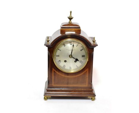 A mahogany inlaid striking mantel clock, retailed Ollivant &amp; Botsford, Manchester; together with four keys in repairers b