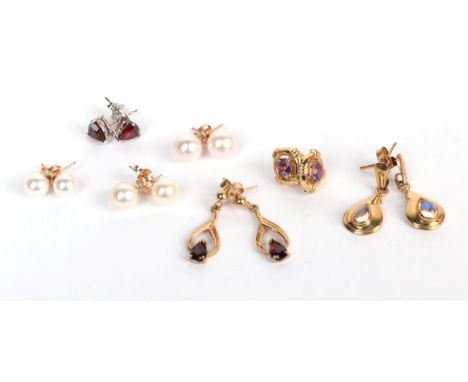 Three pairs of cultured pearl earrings, stamped '375'; a pair of garnet stud earrings, stamped '375'; a pair of 9 carat gold 