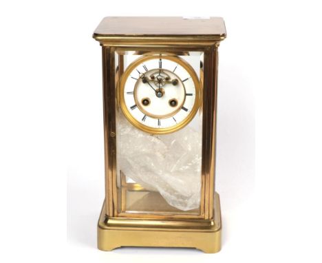 A brass four glass striking mounted clock 