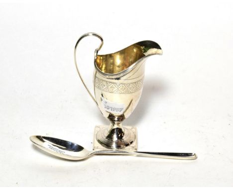 An 18th century silver marrow spoon, marks indistinct London circa 1770; and a helmet shaped pedestal cream jug, London 1796 
