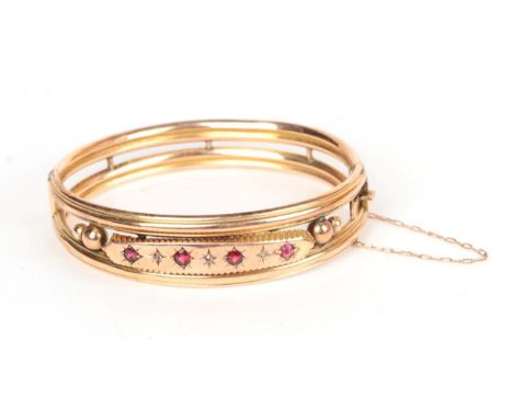 A garnet and rose cut diamond set bangle, stamped '9' '.375', measures 6cm by 4.8cm.  Gross weight 13.40 grams 