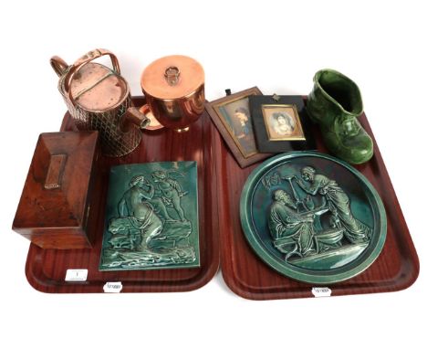 Two early 20th century green glaze moulded plaques; a copper ice cream bombe; a copper watering can; a green glaze boat; two 