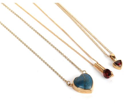 Two garnet pendants on 9 carat gold chains, chain lengths 41cm and 45cm; and a 9 carat gold lapis lazuli necklace, chain leng