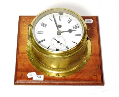A brass ships bulk head clock, single fusee movement with a platform escapement and maintaining power 
