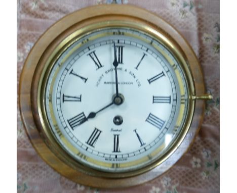 Brass cased Ships Bulkhead Clock by Henry Browne &amp; Sons: mounted, diameter of dial 14.5cm 