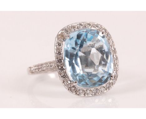 A large baguette cut blue topaz, diamond, platinum dress ring, the topaz set within a micro set diamond surround and shank.