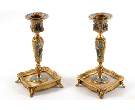 A pair of fine early 20th Century Continental gilt bronze candlestickds, blue celest&egrave; enamelled with Champlev&egrave; 