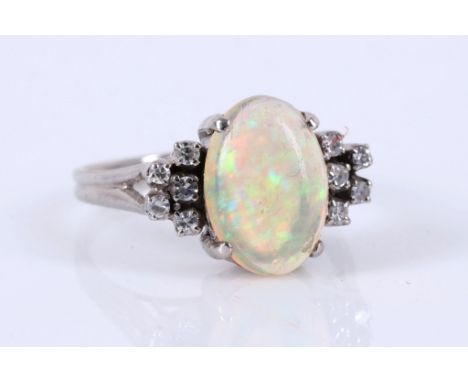 An 18ct white gold, cabochon opal and diamond set ring.