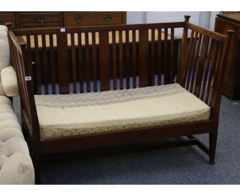 An Edwardian mahogany two seater sofa, with slatted back and sides.