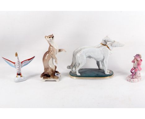A Nymphenberg porcelain figure of a stoat sold together with a Karl Ernst group of borzoi dogs and a figure of a frog playing