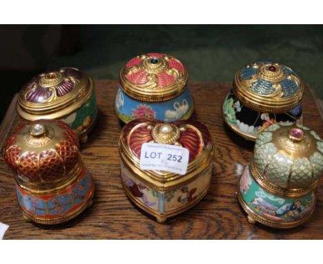 A collection of six ceramic musical table boxes, decorative and gilded with removable covers (6)