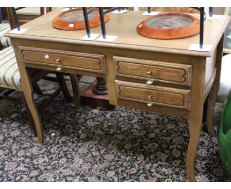 A light oak desk with three drawers