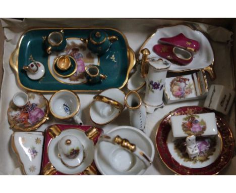 A collection of Limoges ceramic miniatures, includes a tea set, chamber pot, dog kennel etc