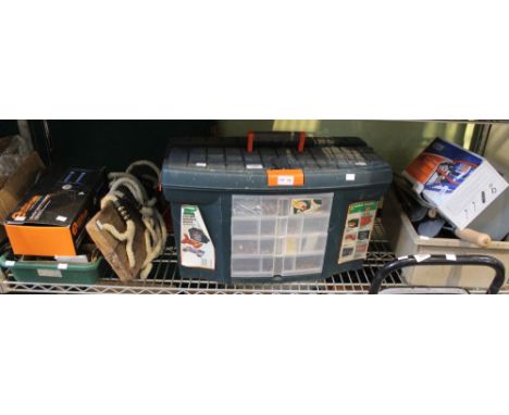 A shelf of tools including an electric hedge trimmer, large tool box, sack truck etc