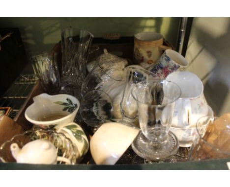 A box of ceramic floral jugs and assorted glassware