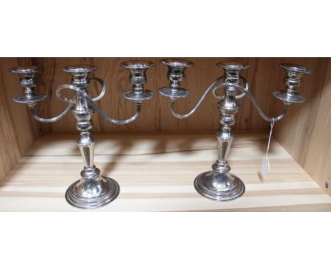 A pair of silver plate on copper candelabra, twin branch, triple light design (2)