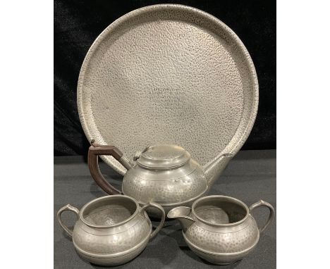 A pewter hammered tea tray engraved ‘Presented to mother and father on the occasion of their silver wedding, April 1914-1939 