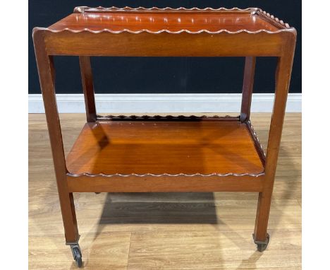 An early 20th century mahogany two-tier buffet serving trolley, each rectangular plateau with wavy three-quarter gallery, 71c