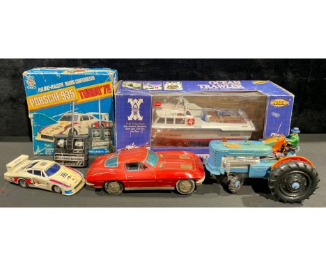 A tin plate battery operated red racing car, M - 101, 29cm wide; a Tricky-Tommy Tractor, battery operated; an Nkok radio cont