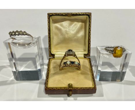 A 9ct gold sapphire and opal ring; an 18ct gold sapphire and diamond ring; etc (4) 