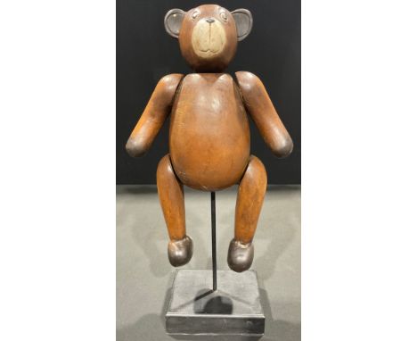 A carved wooden teddy bear 