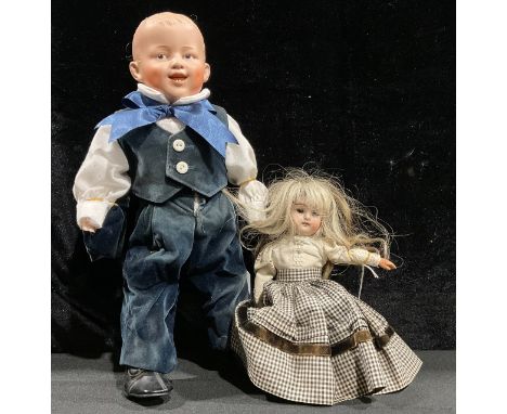 Toys &amp; Juvenalia - a bisque head and doll, the bisque head inset with fixed brown glass eyes, painted features including 