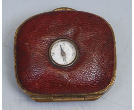 An unusual 19th century red leather coin purse, set with a compass, 5cm wide 