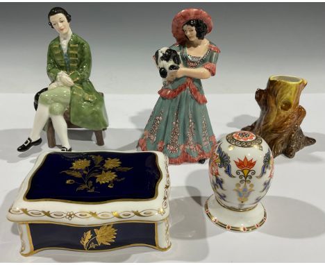 A Royal Crown Derby porcelain egg on stand, Japan, gold button; a Royal Crown Derby spill vase, as a tree stump; a Royal Crow