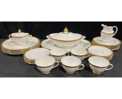 A Royal Doulton Royal Gold pattern dinner service, H 4980, applied with raised tooled gilt borders on a white ground 