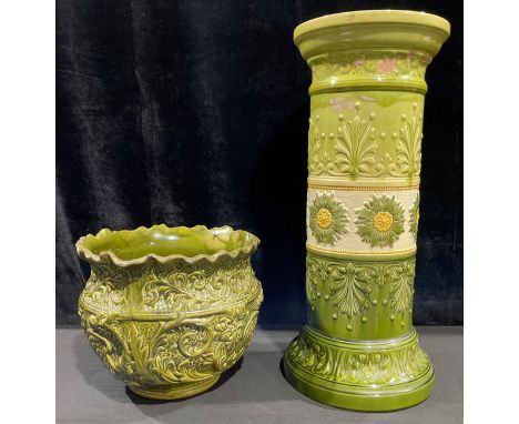A Leeds Art Pottery majolica jardiniere pedestal, moulded in relief with stylised flower heads and stiff leaves, in tones of 