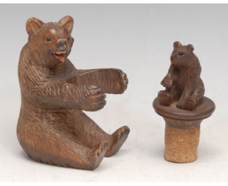 A Black Forest carving, of a bear, 9.5cm high, c.1900; a bottle stopper (2) 