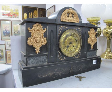 An Early XX Century Slate Cased Mantle Clock, with a round top, gilt mounts, Arabic numerals to brass dial, 47cm wide.