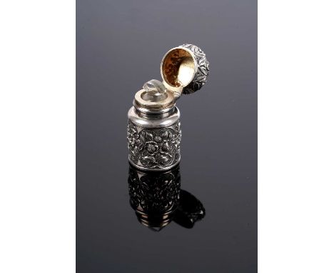 A Victorian silver mounted scent bottle by George Brace, London 1886, with embossed floral decoration, 4.6cms high, in velvet