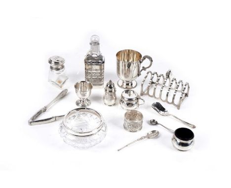 A silver seven bar toast rack; a silver condiment bottle stand (with glass bottle); and other silver and plated items, includ