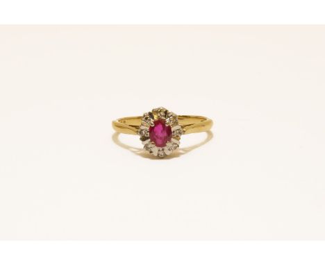 An 18ct gold ruby and diamond illusion set cluster ring, size N3.01g