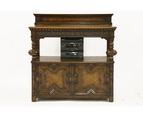 A honey oak buffet, the mould rectangular top above shelf with a pair of cupboards underneath on square section feet, 100 cm 