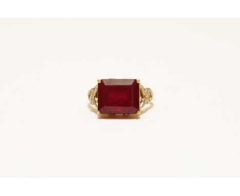 A 9ct gold step cut single stone ruby ring, with diamond set shoulders, size N5.45g